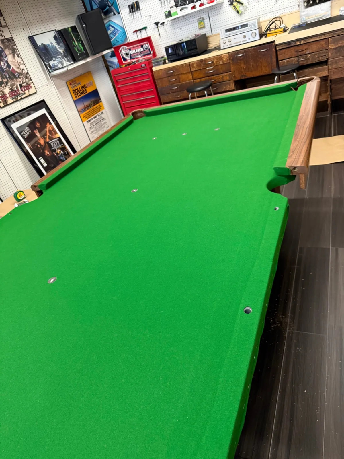 Green cloth installed on a professionally reassembled pool table