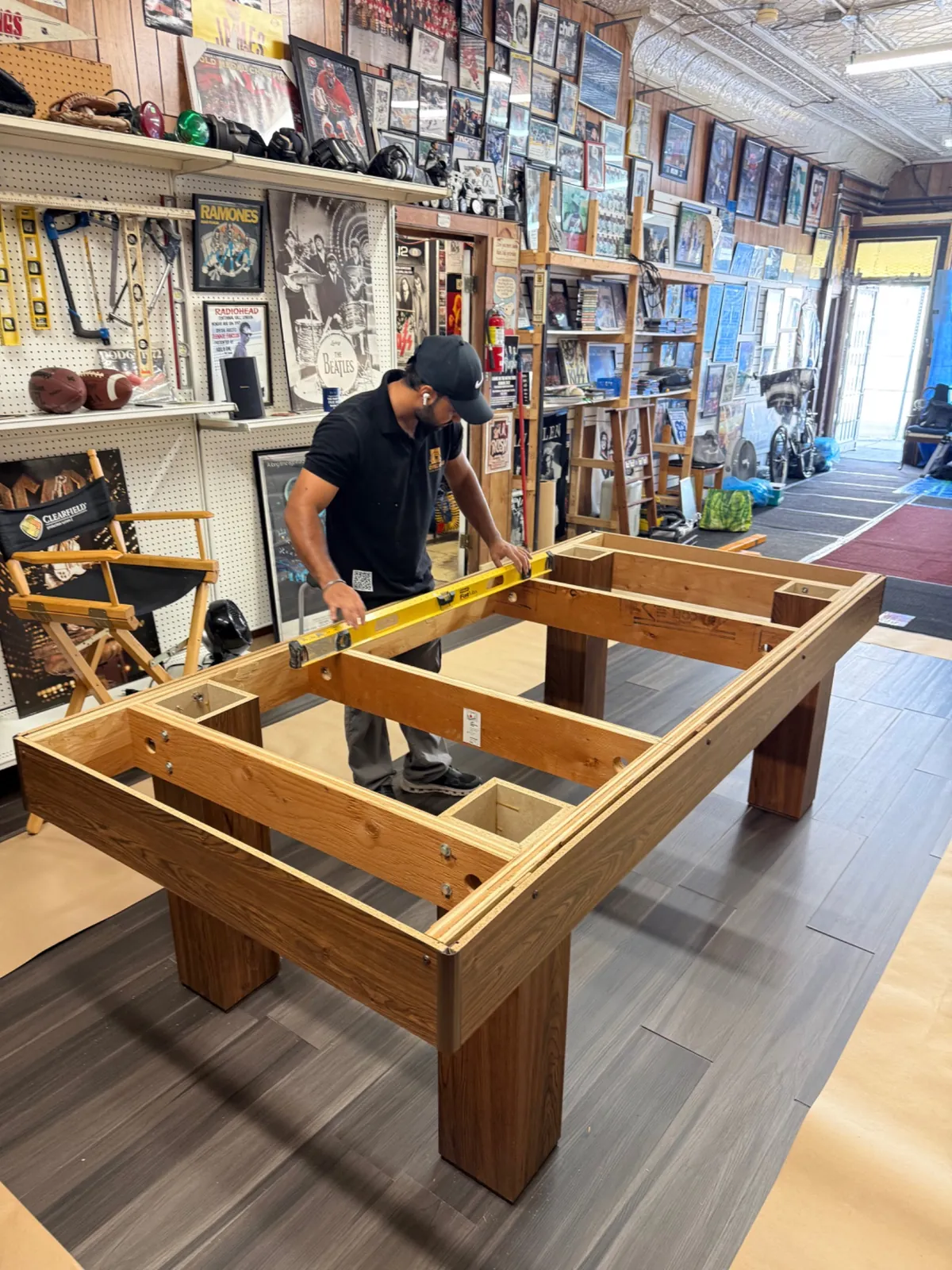 Pool table frame being checked with a spirit level