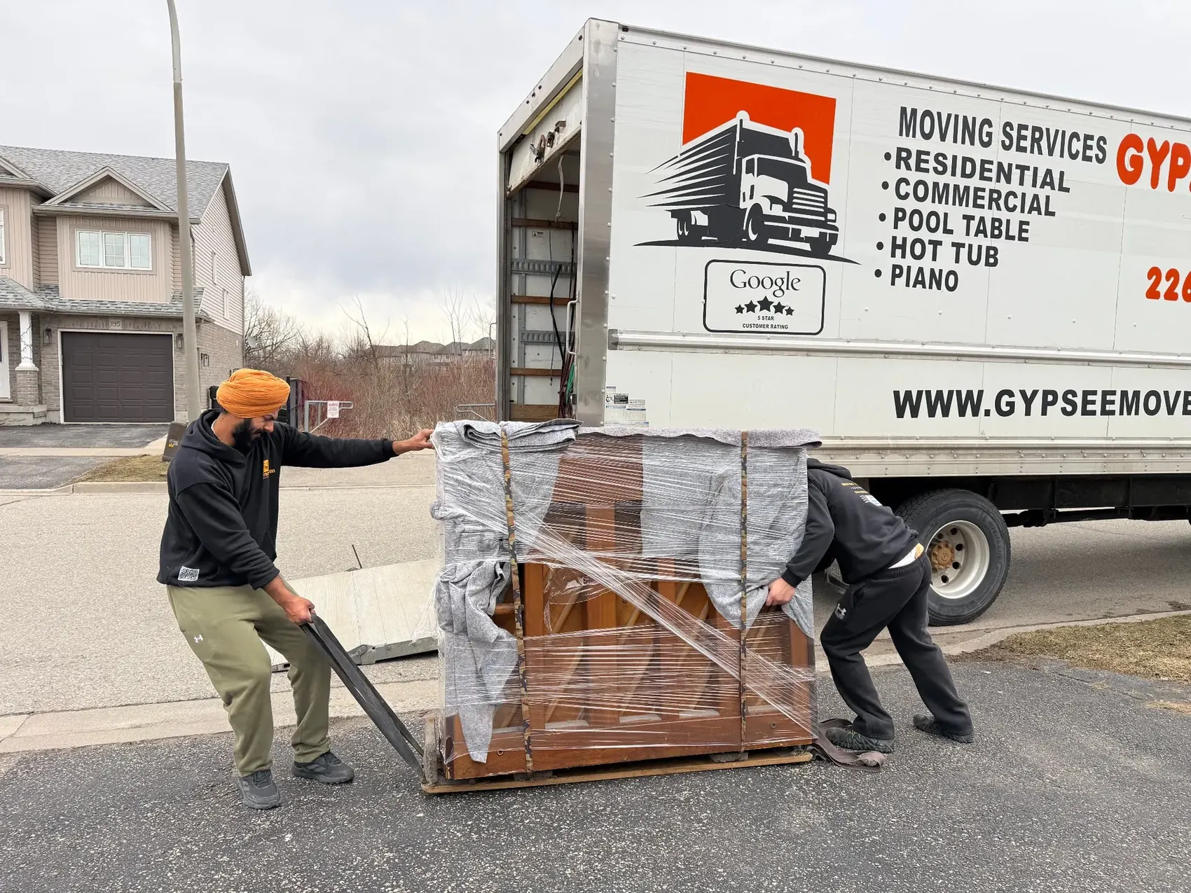 Gypsee Movers commercial movers protecting wrapped furniture for a London Ontario business move