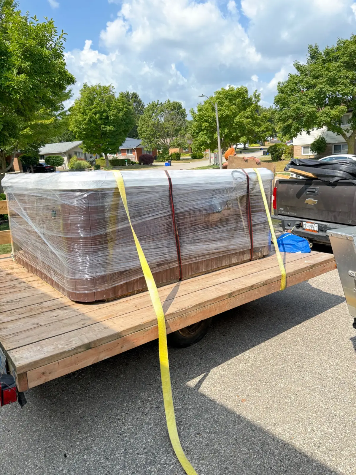 Wrapped hot tub secured on trailer for transport in Waterloo Region