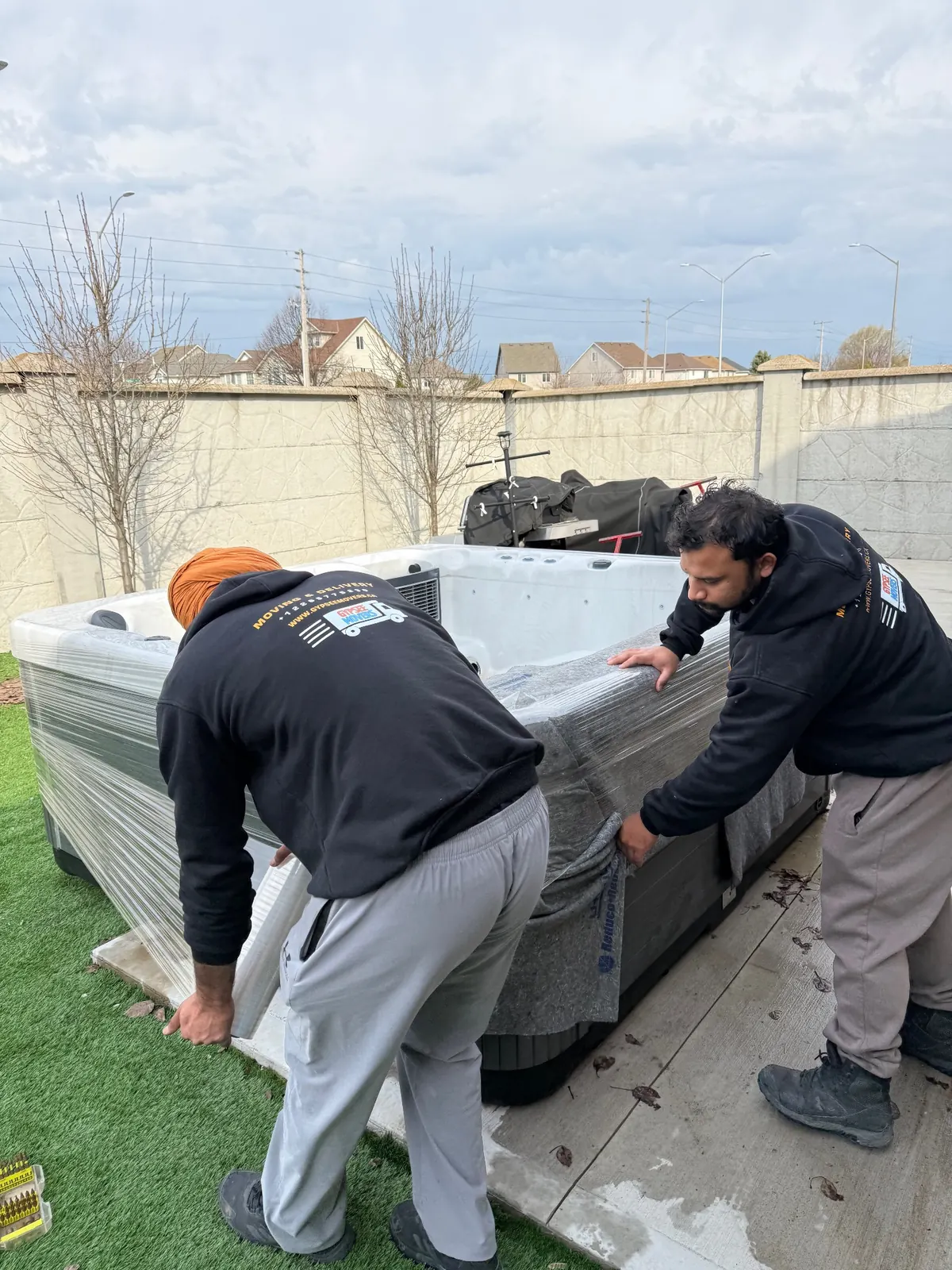 Gypsee Movers wrapping and protecting a hot tub before moving