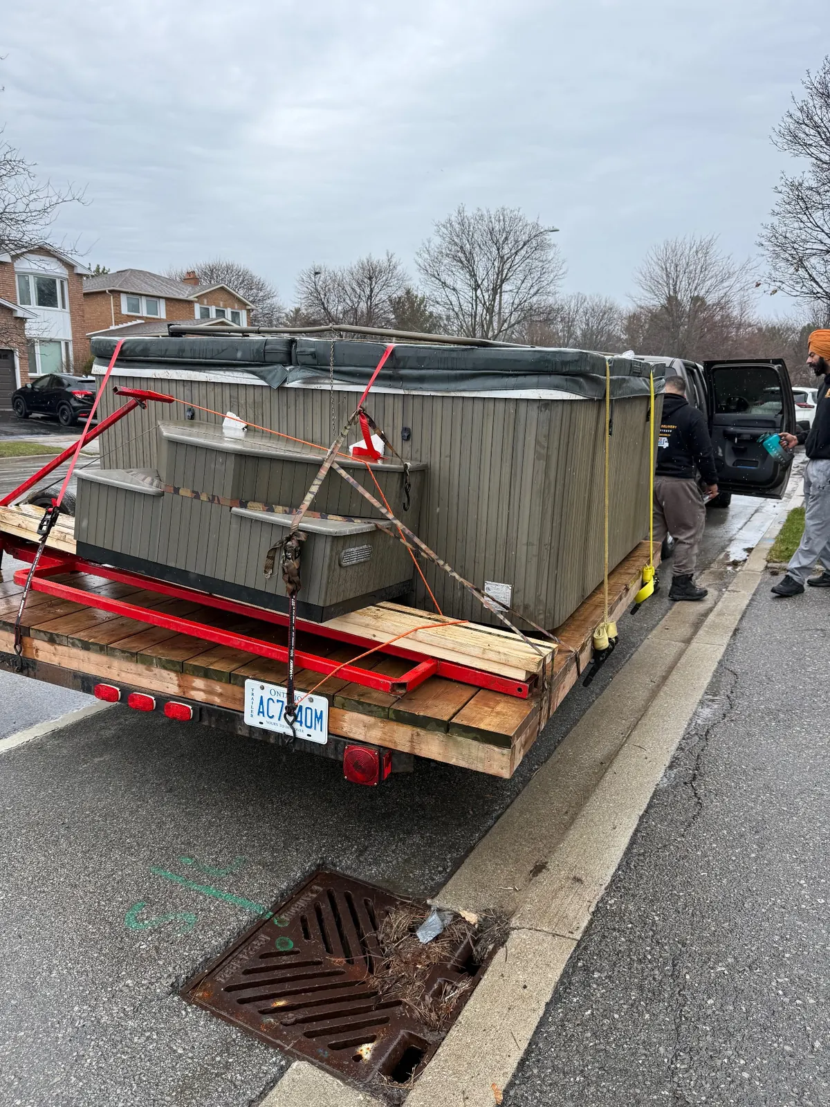 Hot tub strapped securely on a trailer for transport