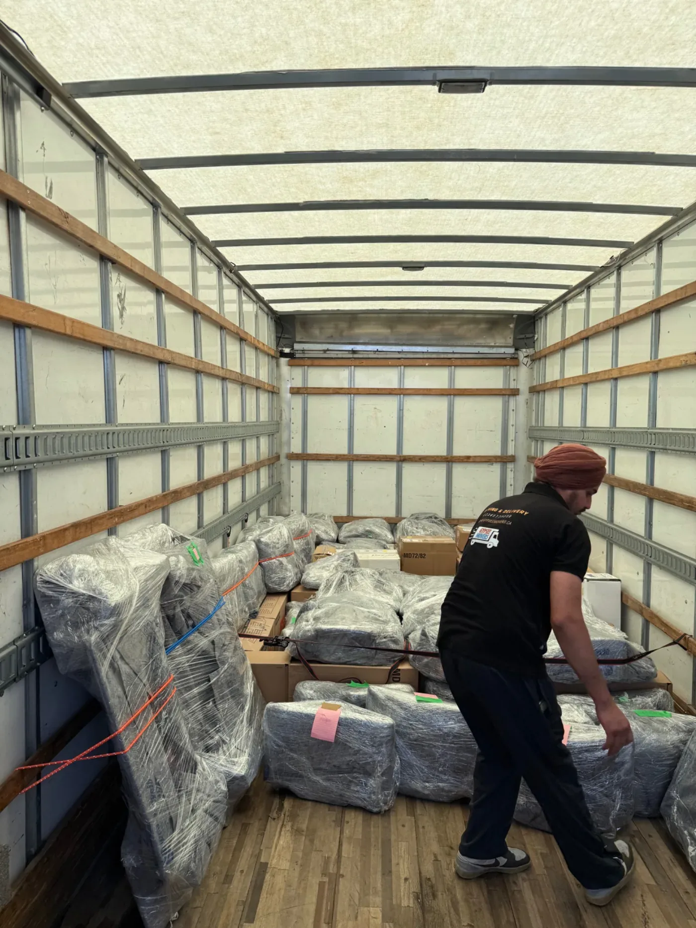 Gypsee Movers commercial moving crew with wrapped office furniture and boxes loaded safely inside the moving truck