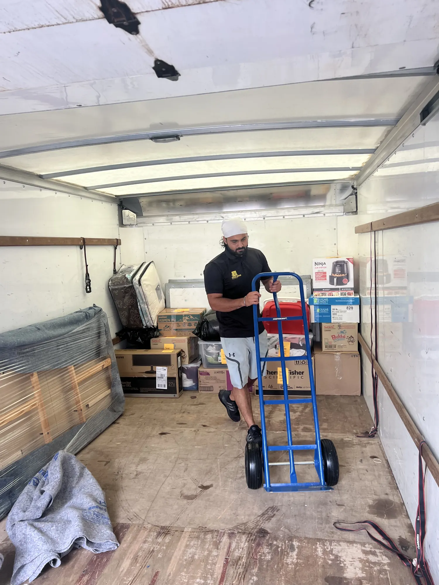 Labor only movers with moving dolly inside truck