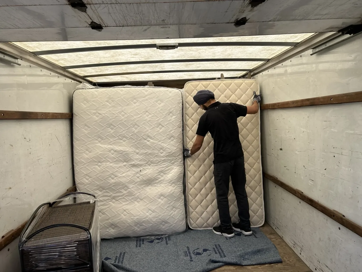 Gypsee Movers local moving crew loading mattresses safely inside a moving truck