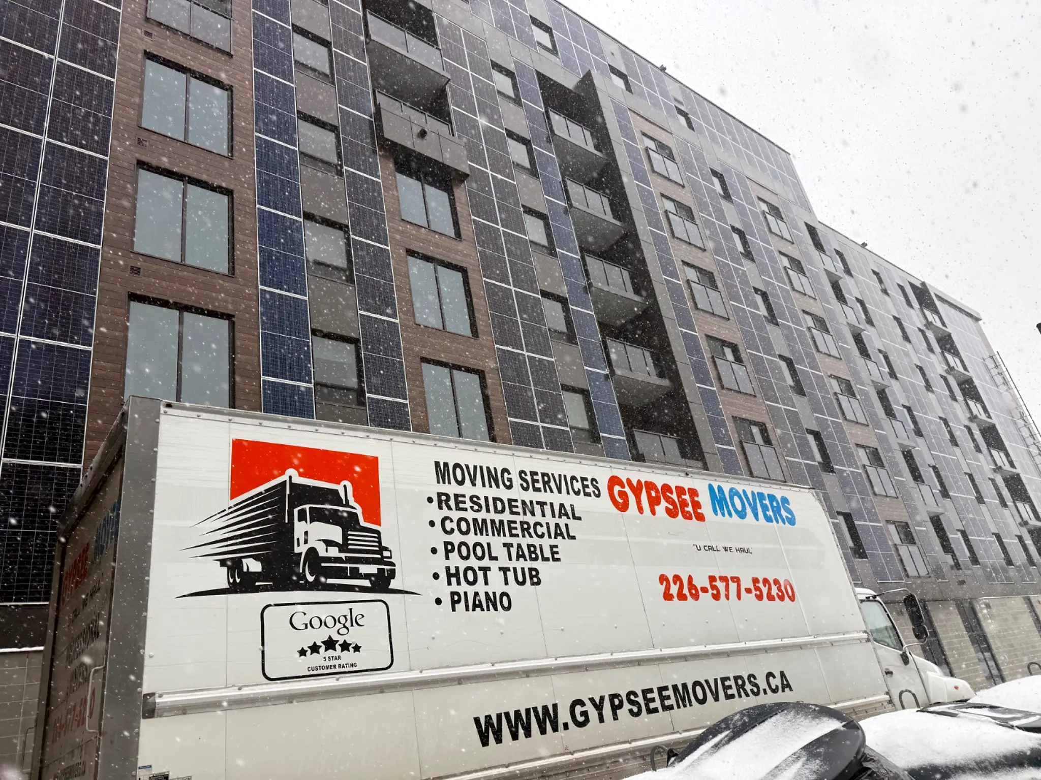 Gypsee Movers truck outside a London Ontario apartment building in winter