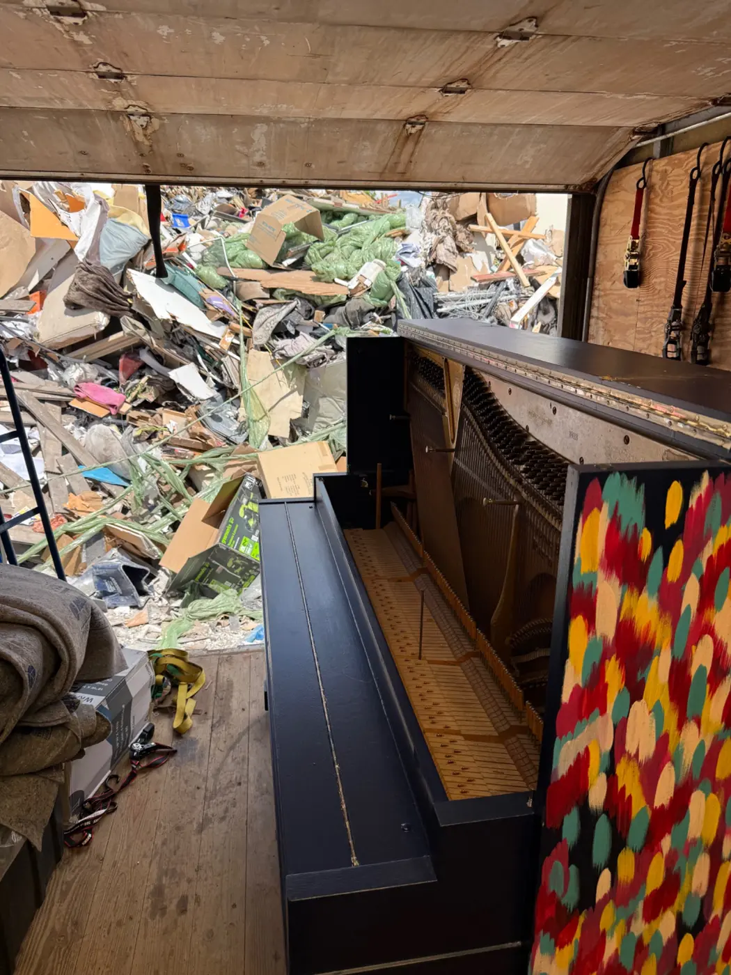 Upright piano loaded in a Gypsee Movers truck for removal
