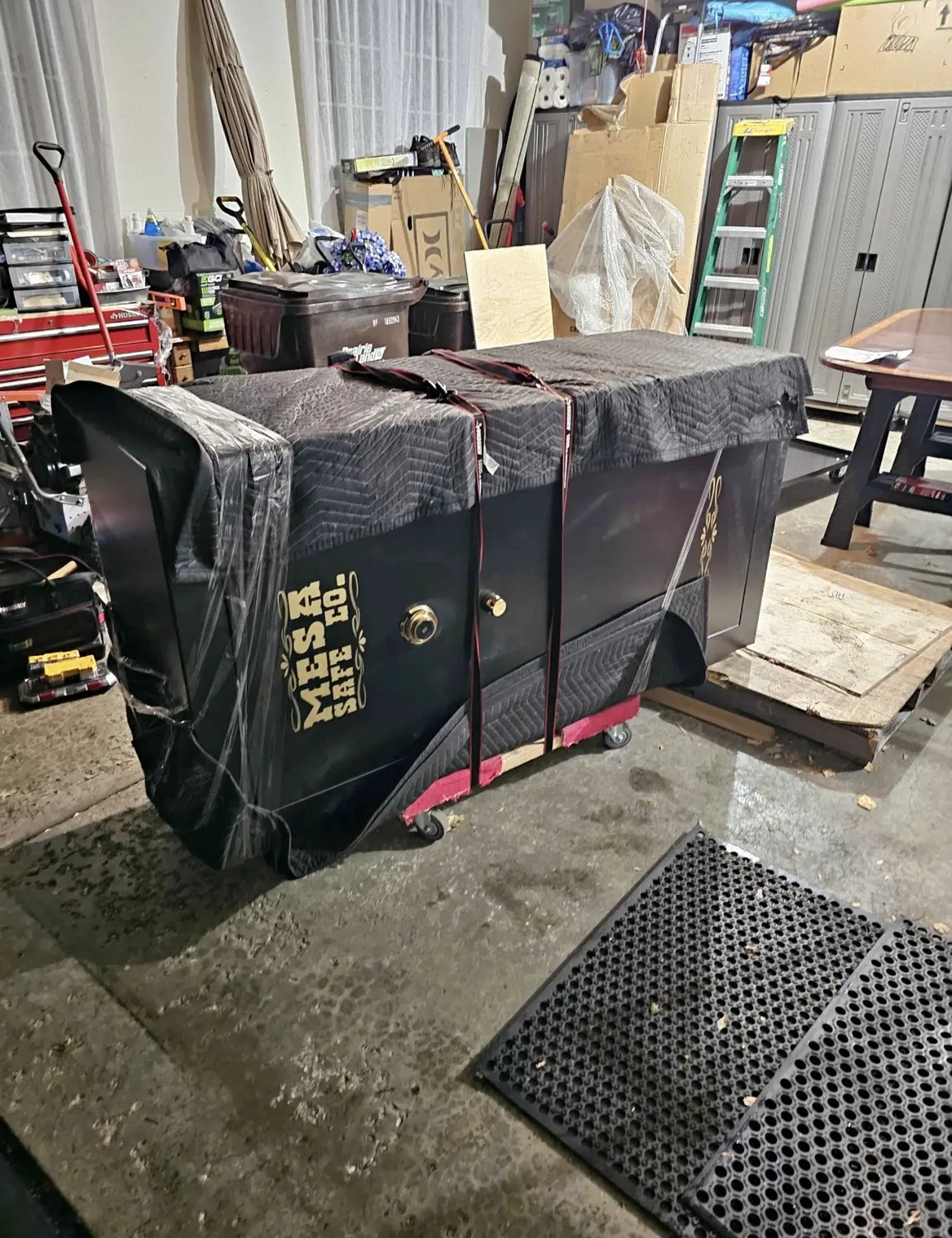 Commercial safe protected with moving blankets and straps
