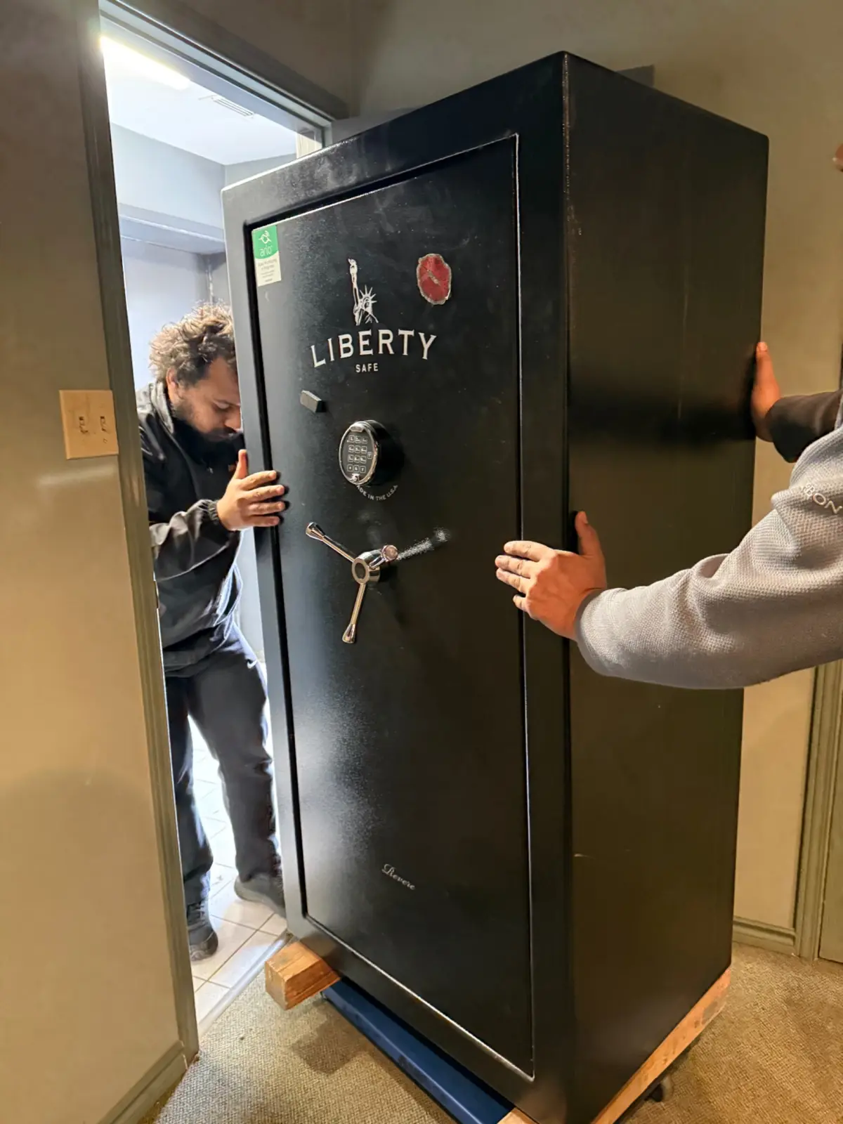 Gypsee Movers carefully moving a large safe through a doorway in London Ontario