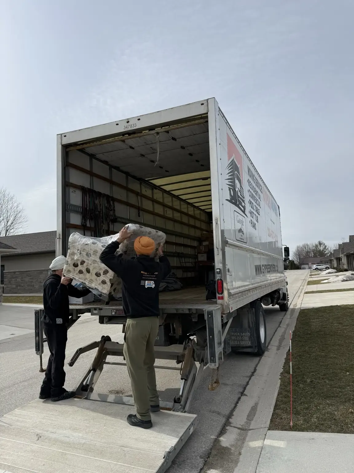 Wrapped furniture and cushions loaded into a moving truck