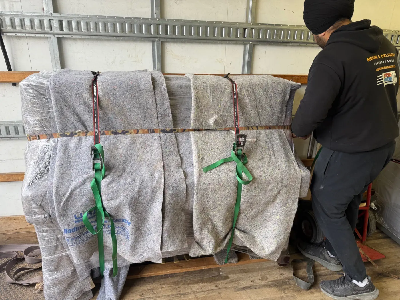 Furniture wrapped and secured inside moving truck