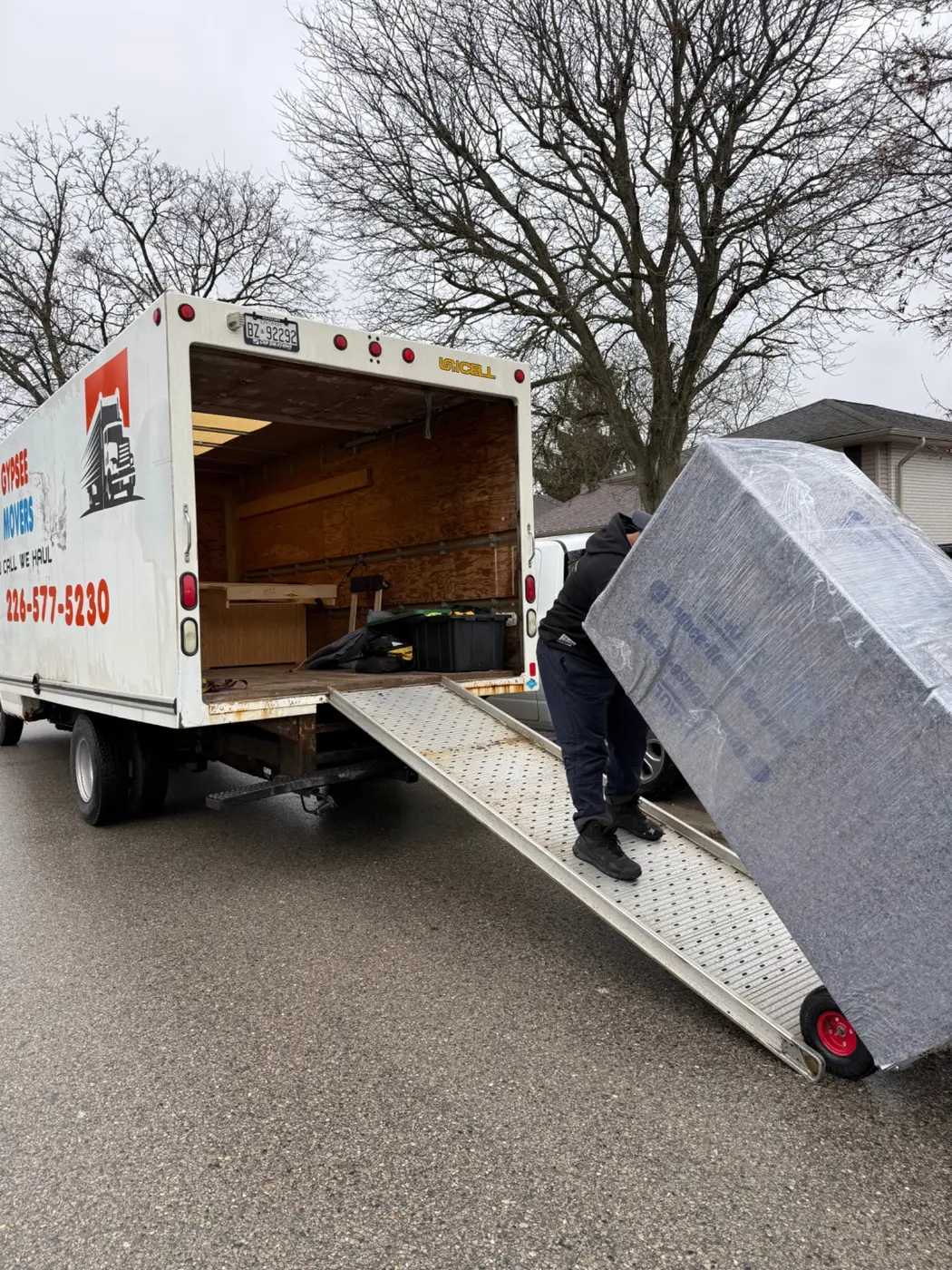 Mover loading wrapped specialty item using truck ramp