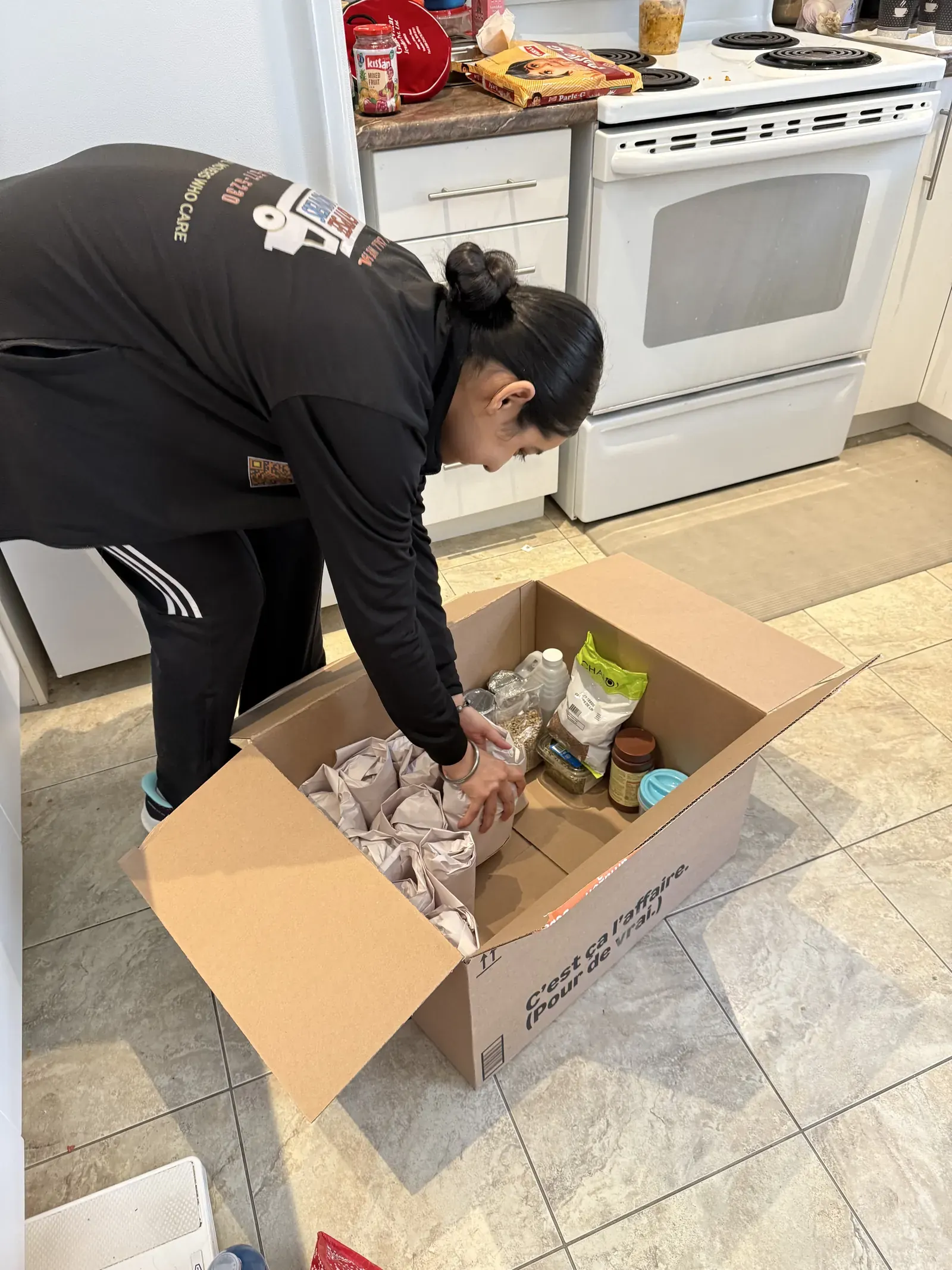 Gypsee Movers packing kitchen items into a box