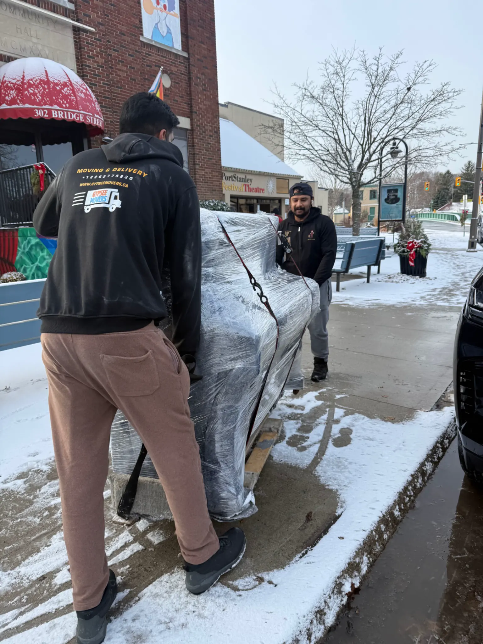 Piano movers using professional equipment