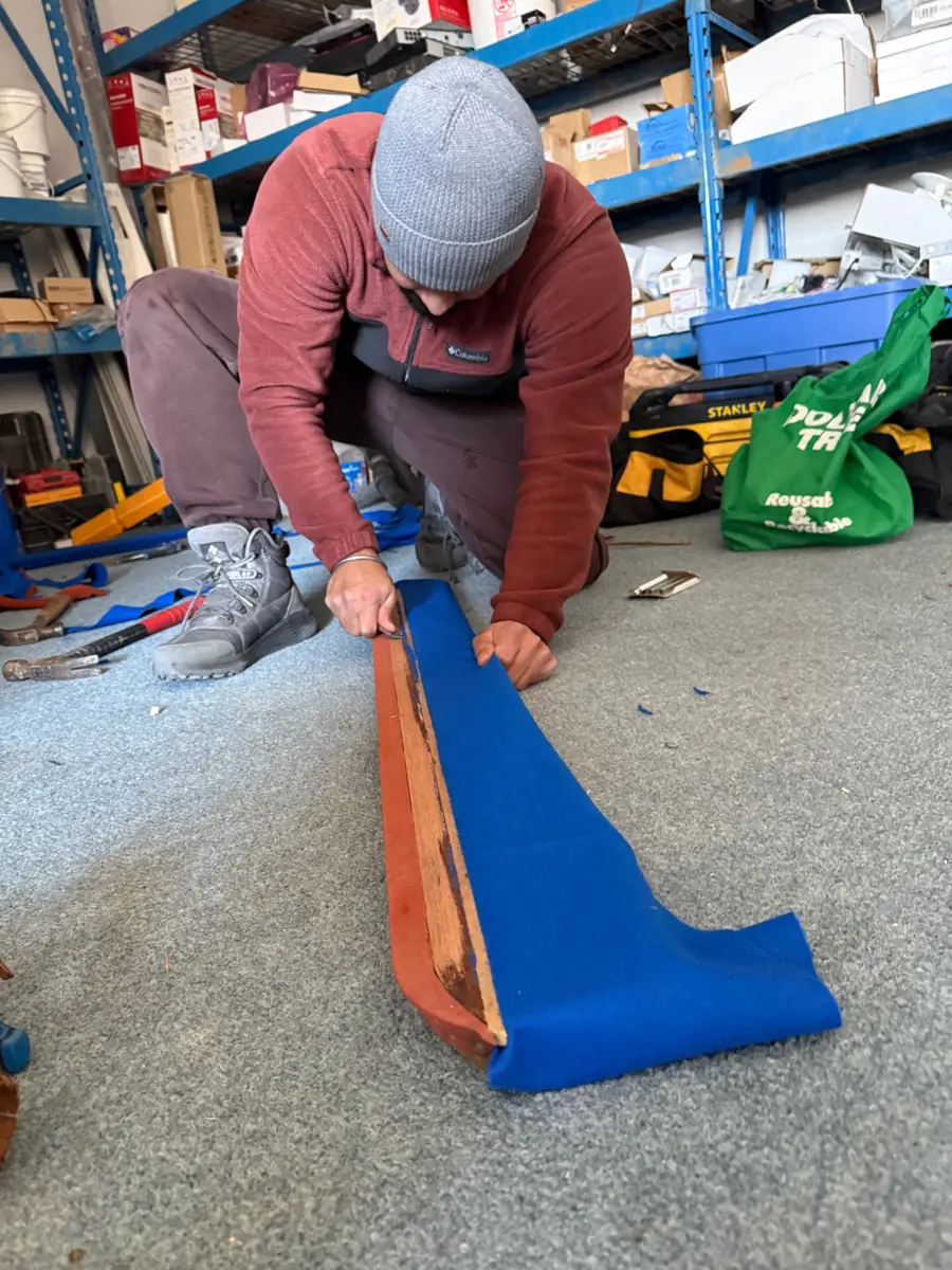 Pool table rail being prepared for new cushion rubber
