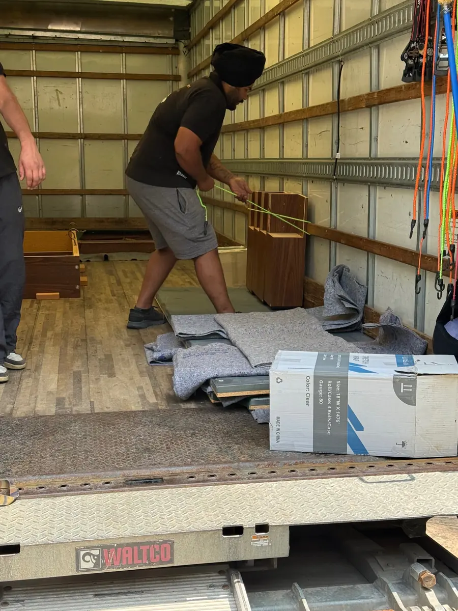 Pool table components protected with moving blankets inside the truck