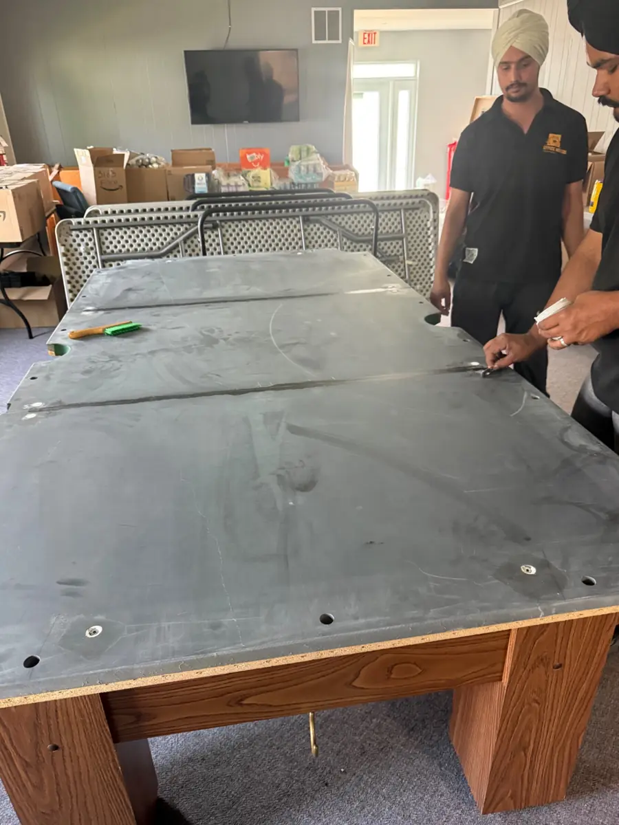 Pool table slate seams being professionally sealed with beeswax