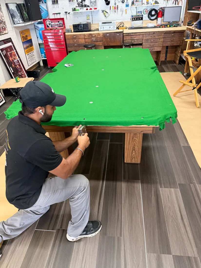 Securing pool table felt during professional setup