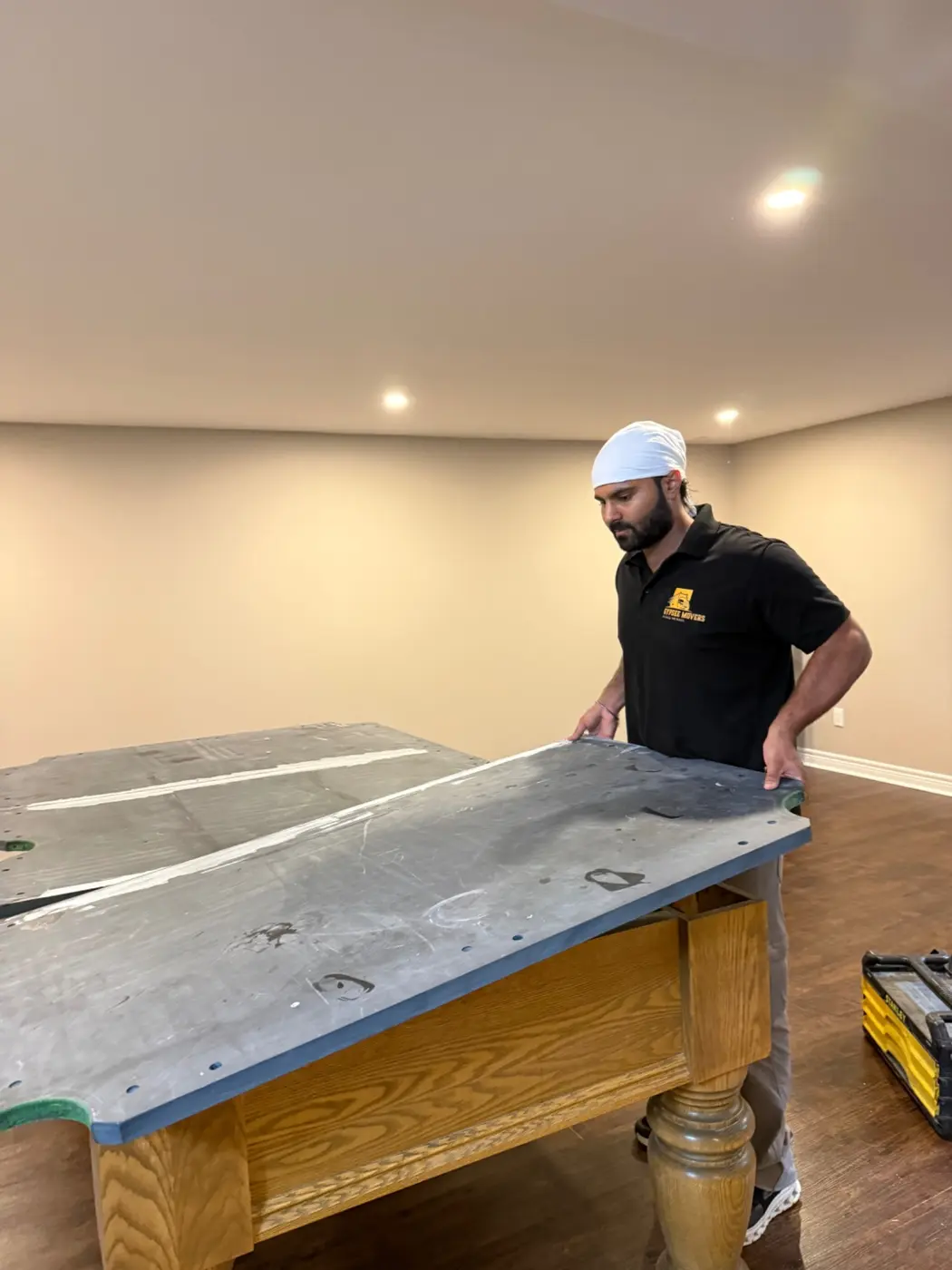 Pool table base carefully assembled before slate installation