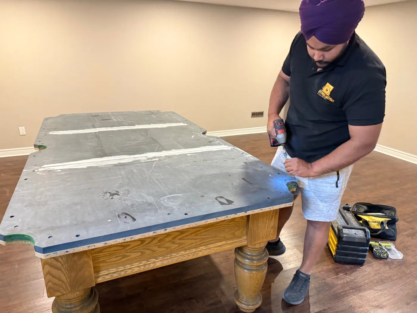 Pool table slate seams being prepared and sealed