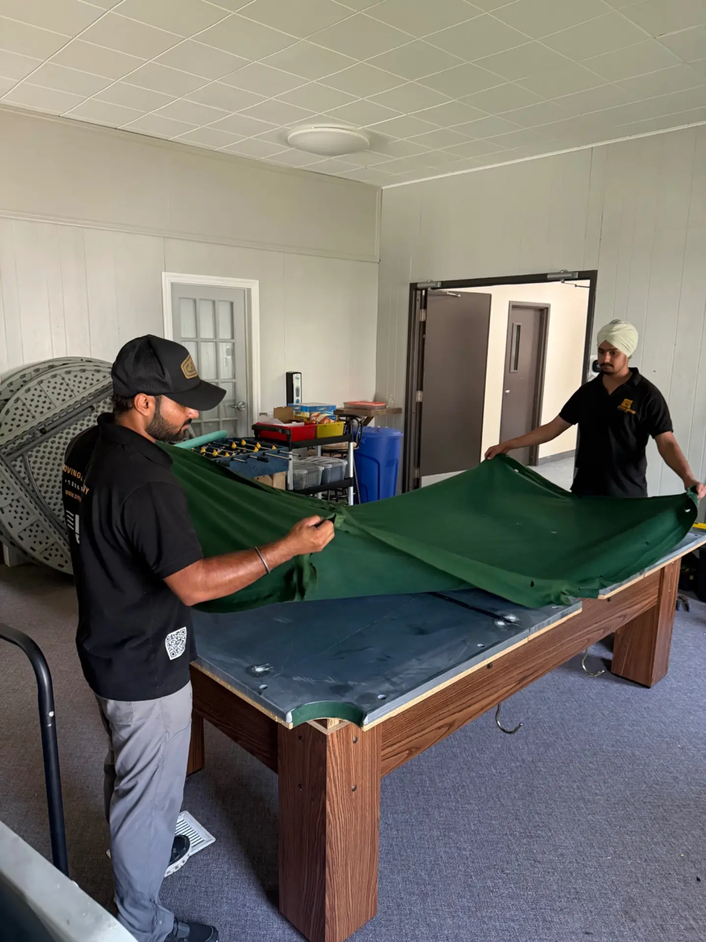 Gypsee Movers technicians working on a slate pool table in Woodstock Ontario