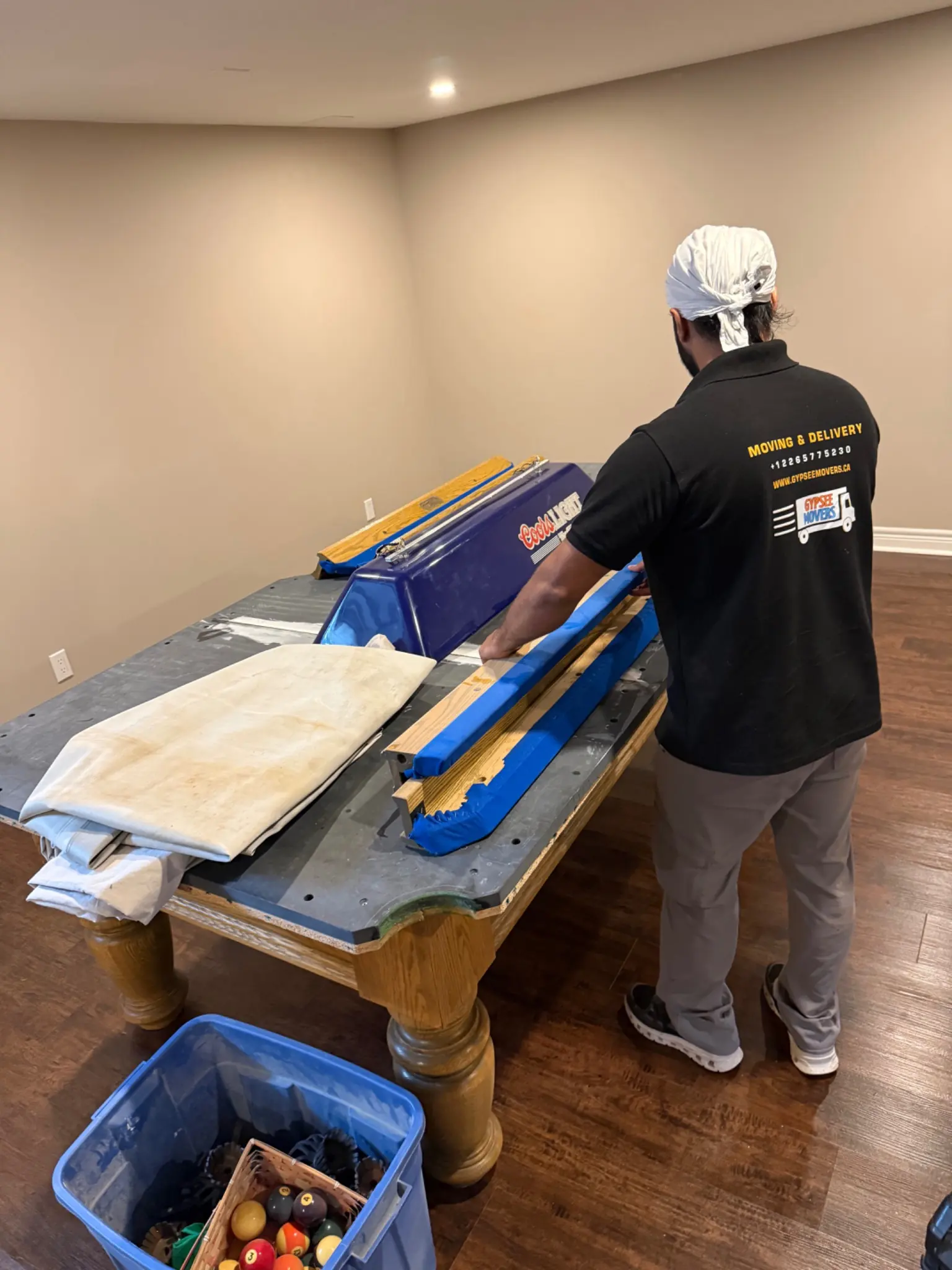 Gypsee Movers disassembling a pool table in London Ontario