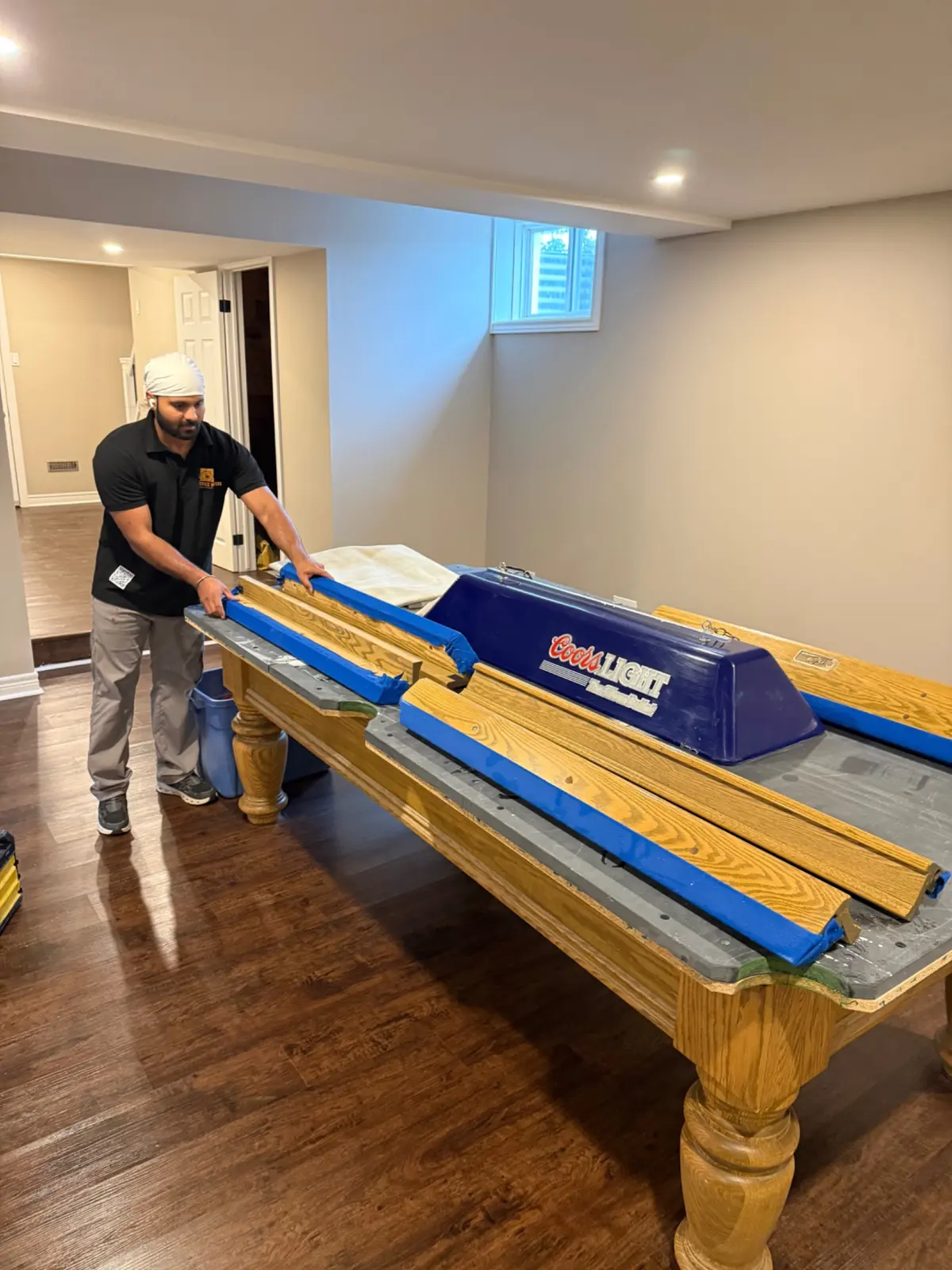 Pool table rails and cushions removed for service