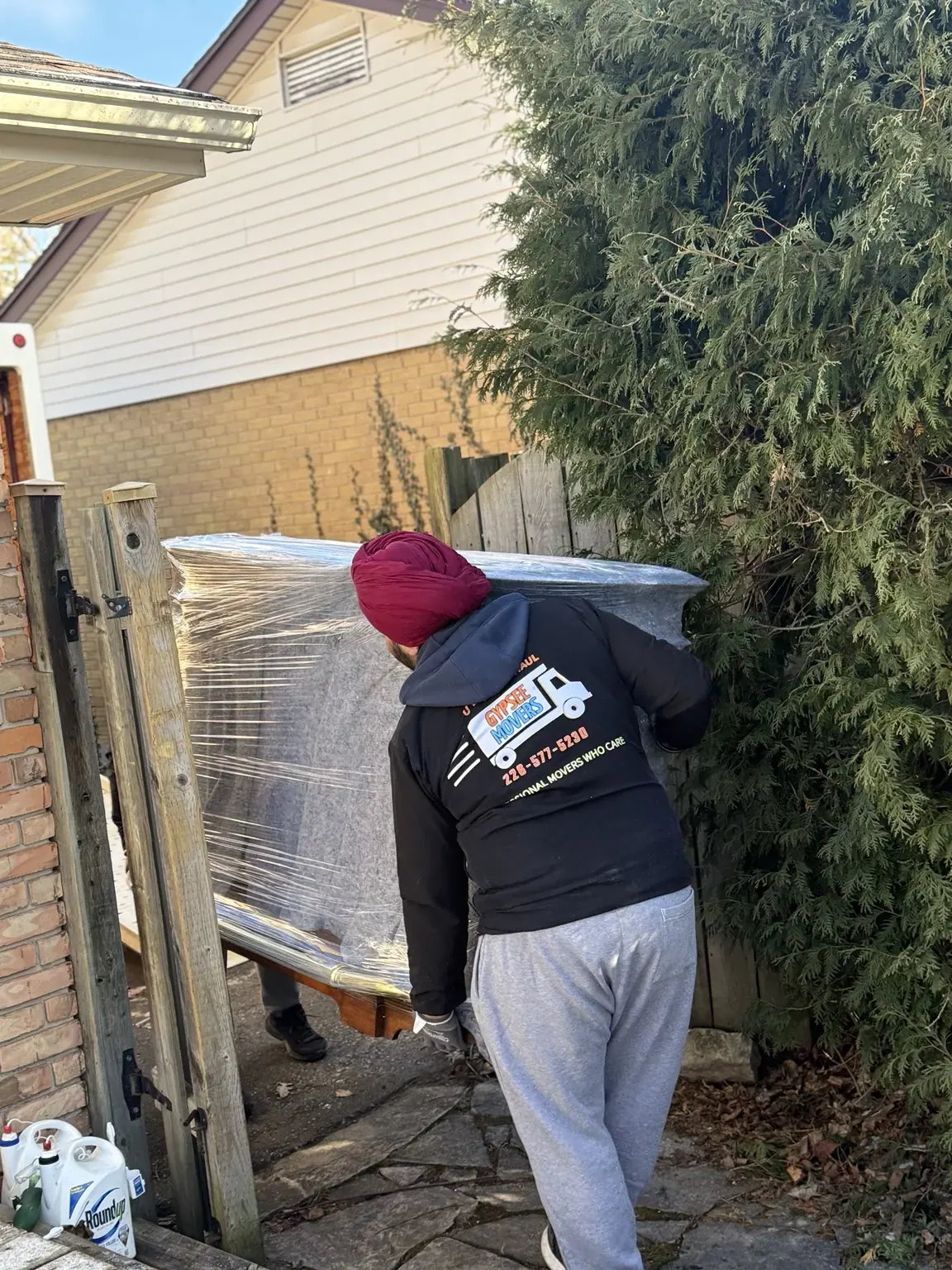 Gypsee Movers team handling heavy household furniture during a residential move