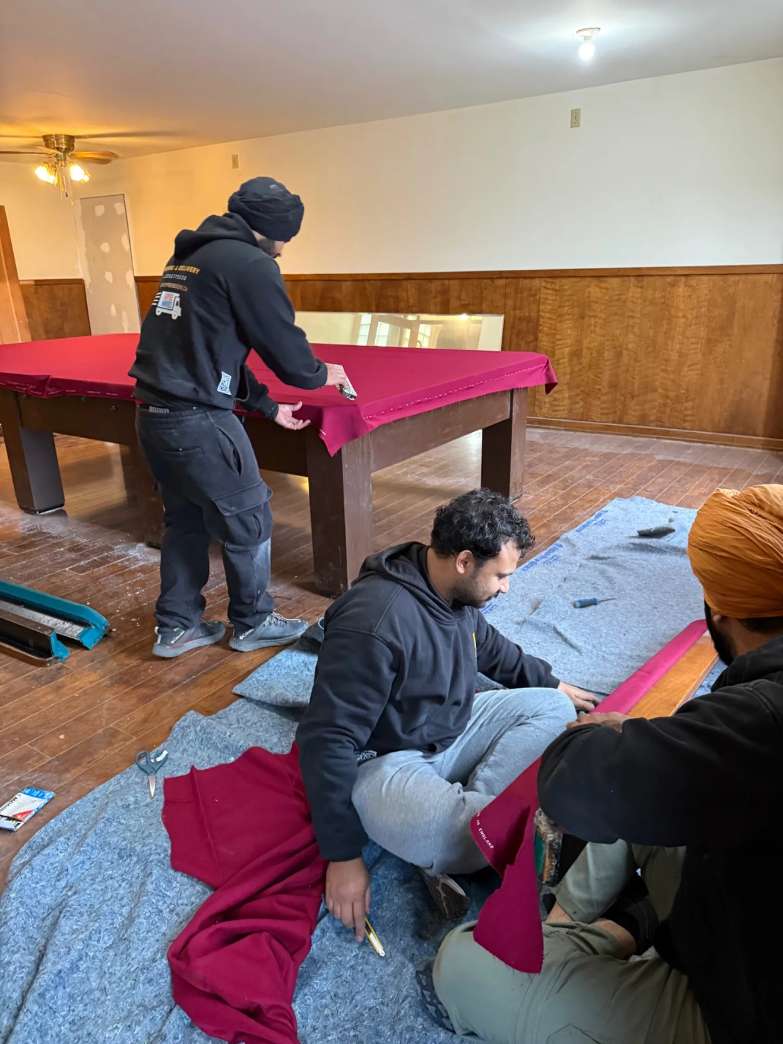 Gypsee Movers disassembling and refelting a five-piece slate snooker table