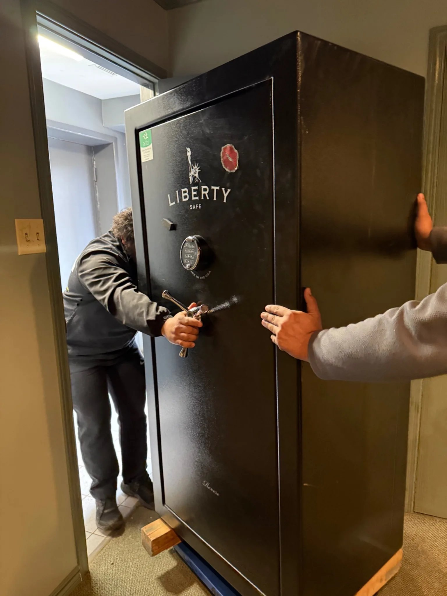 Gypsee Movers relocating a 1200 pound Liberty safe through a narrow stairway using a hydraulic safe dolly during a move from London Ontario to Tillsonburg Ontario.