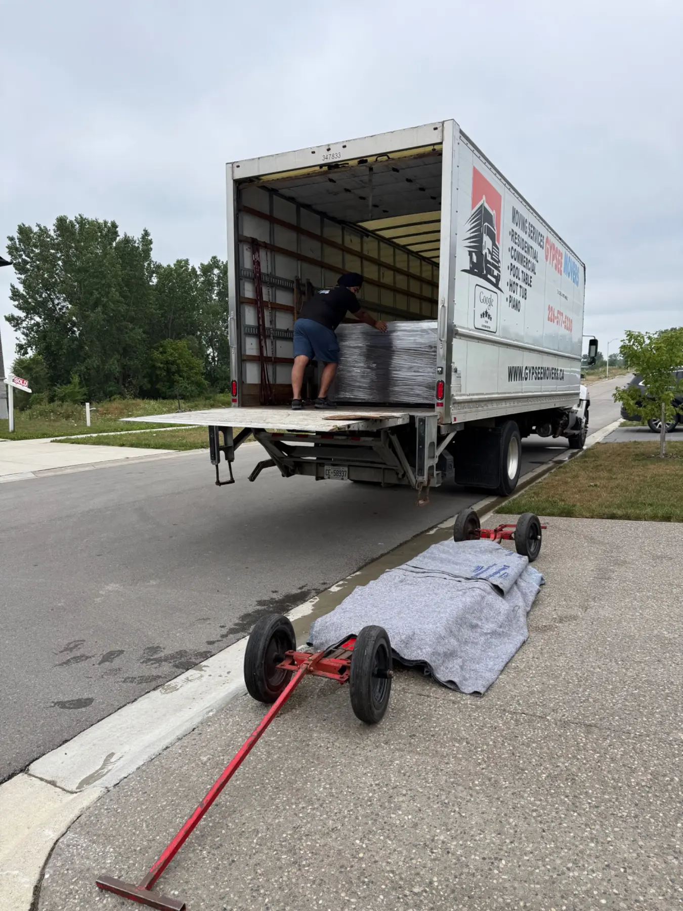 Gypsee Movers truck being loaded for a flat-rate move