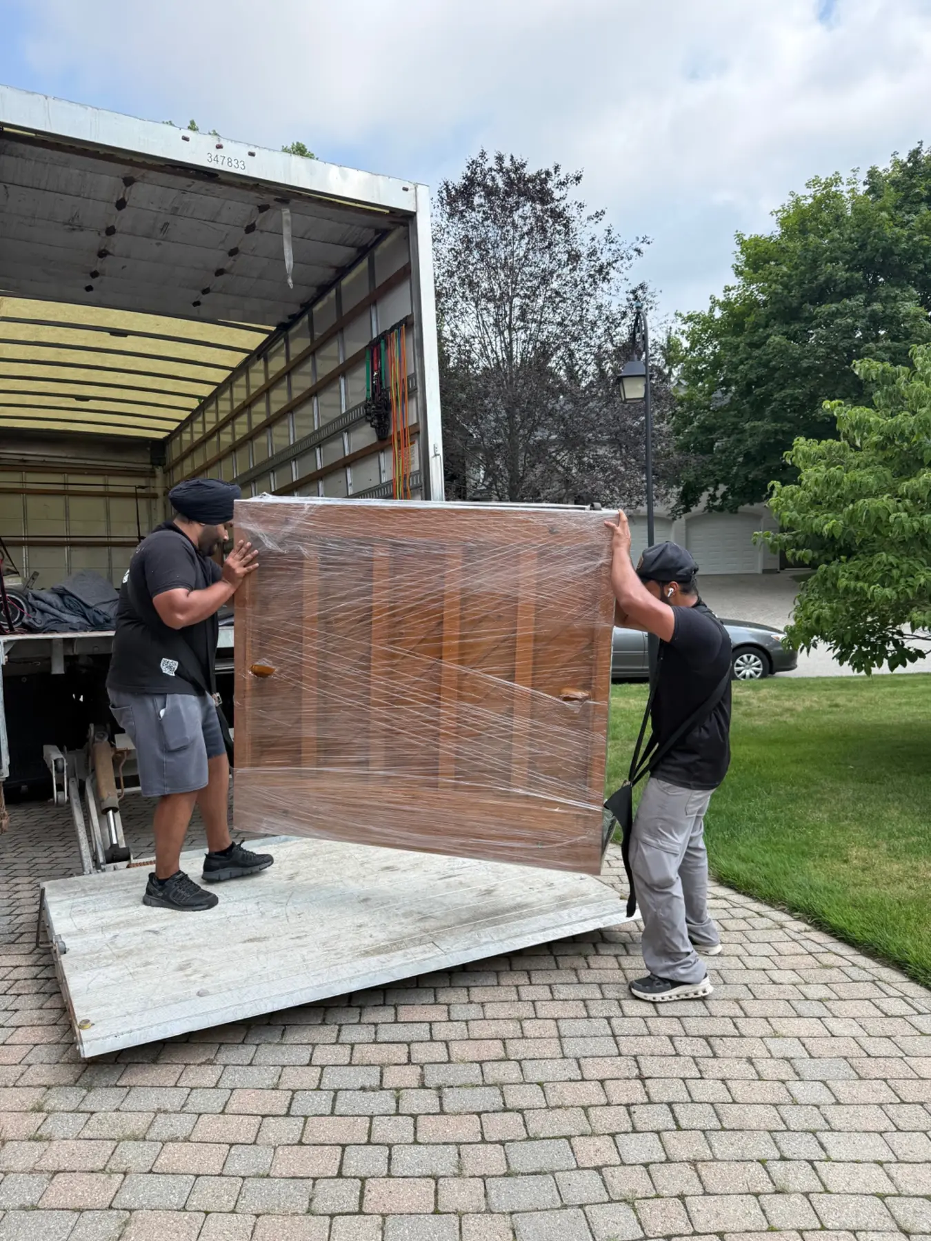 Gypsee Movers loading a protected upright piano near St. Thomas Ontario