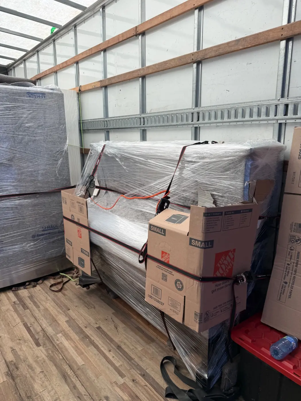 Piano wrapped with blankets, plastic and side protection