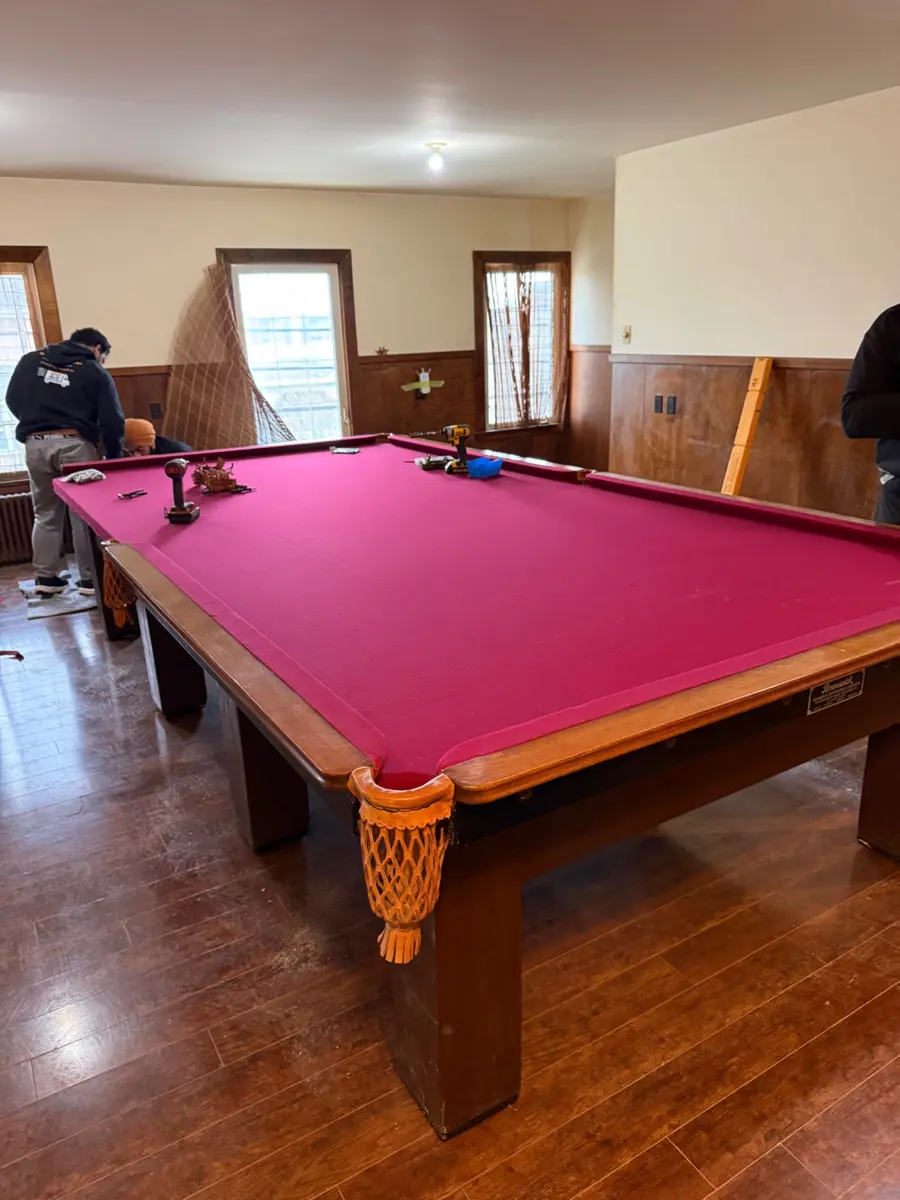 Large antique billiard table with burgundy cloth