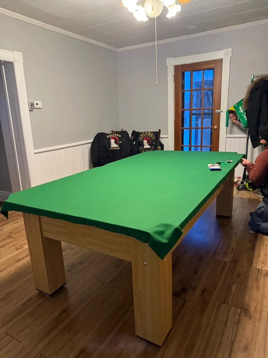 Completed green felt pool table ready for play