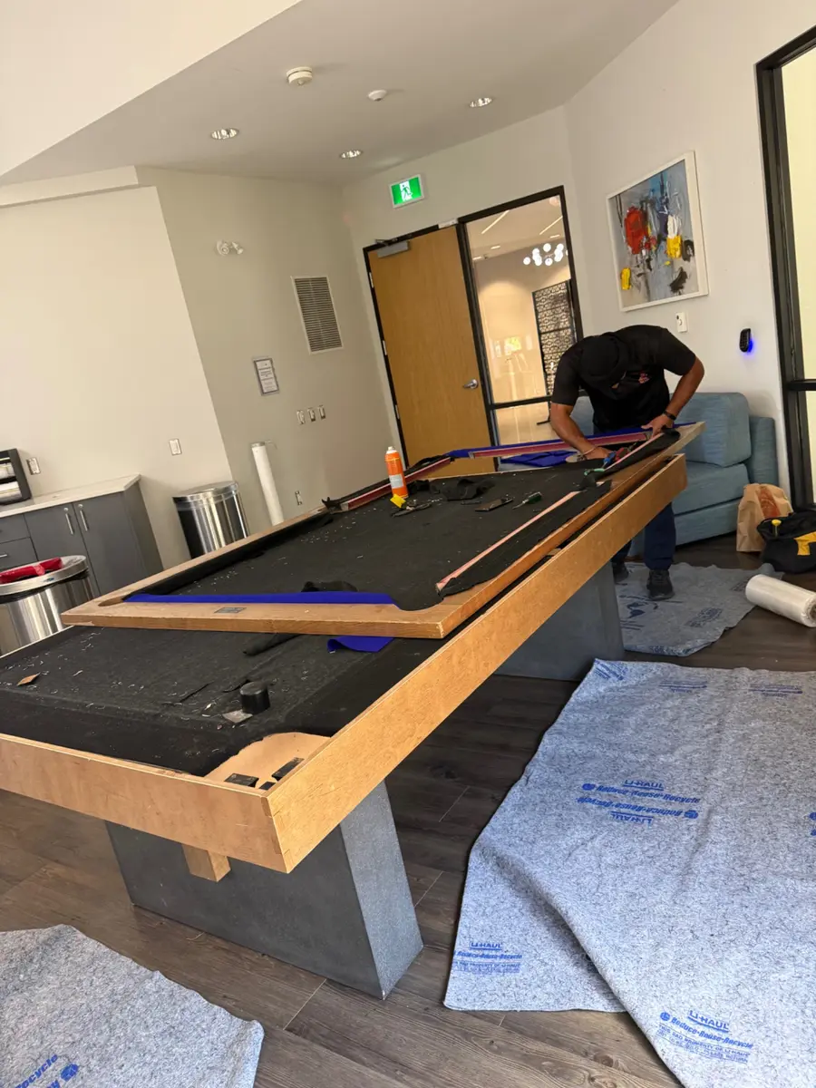 Pool table dismantled with moving blankets ready for protection