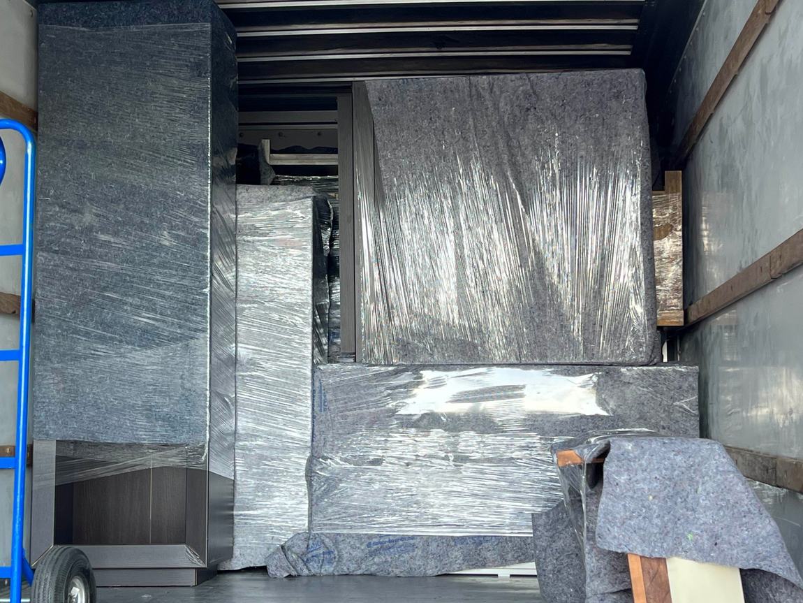 Fully packed moving truck with furniture wrapped and protected by Gypsee Movers