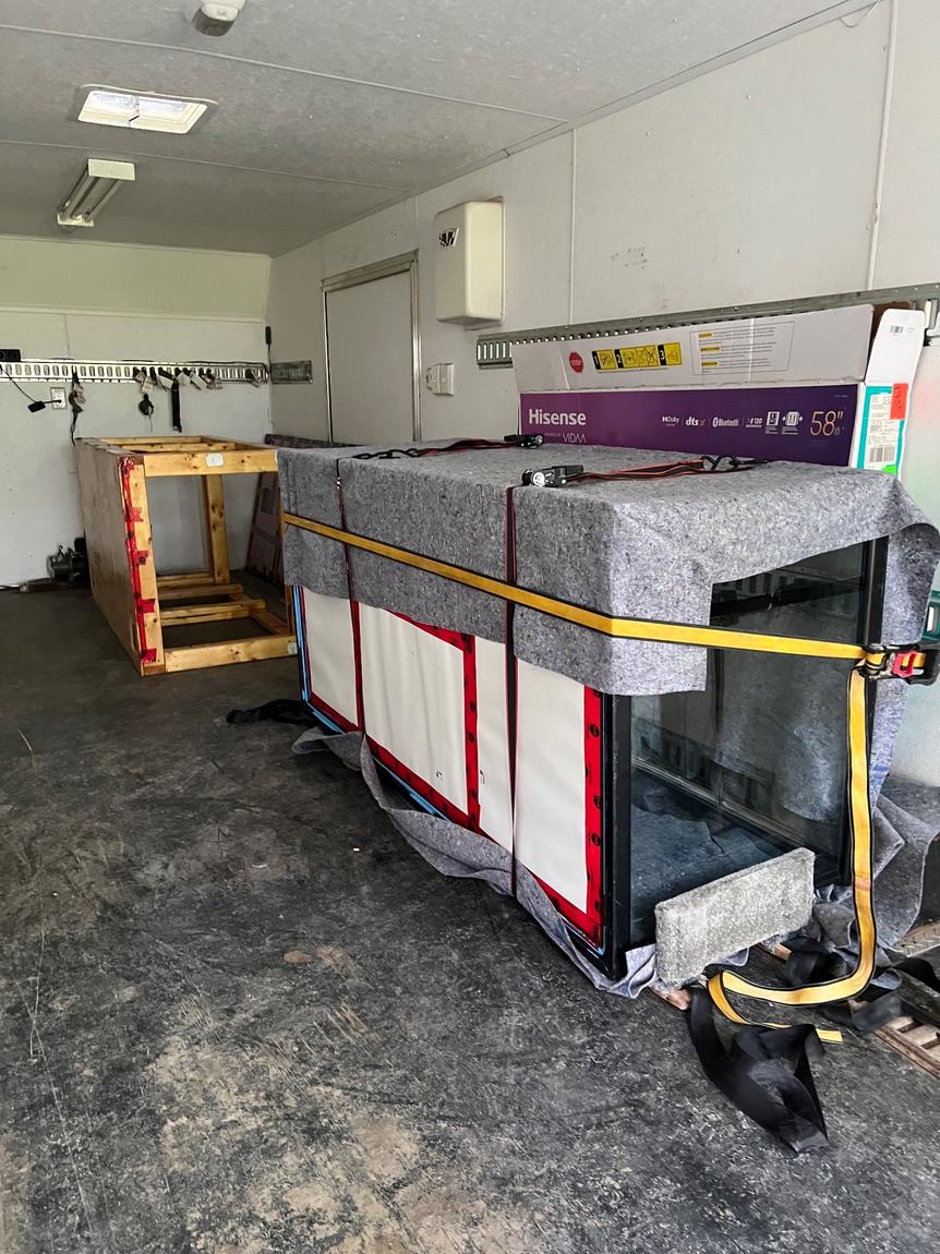 TV and furniture wrapped in moving blankets and secured inside a Gypsee Movers truck