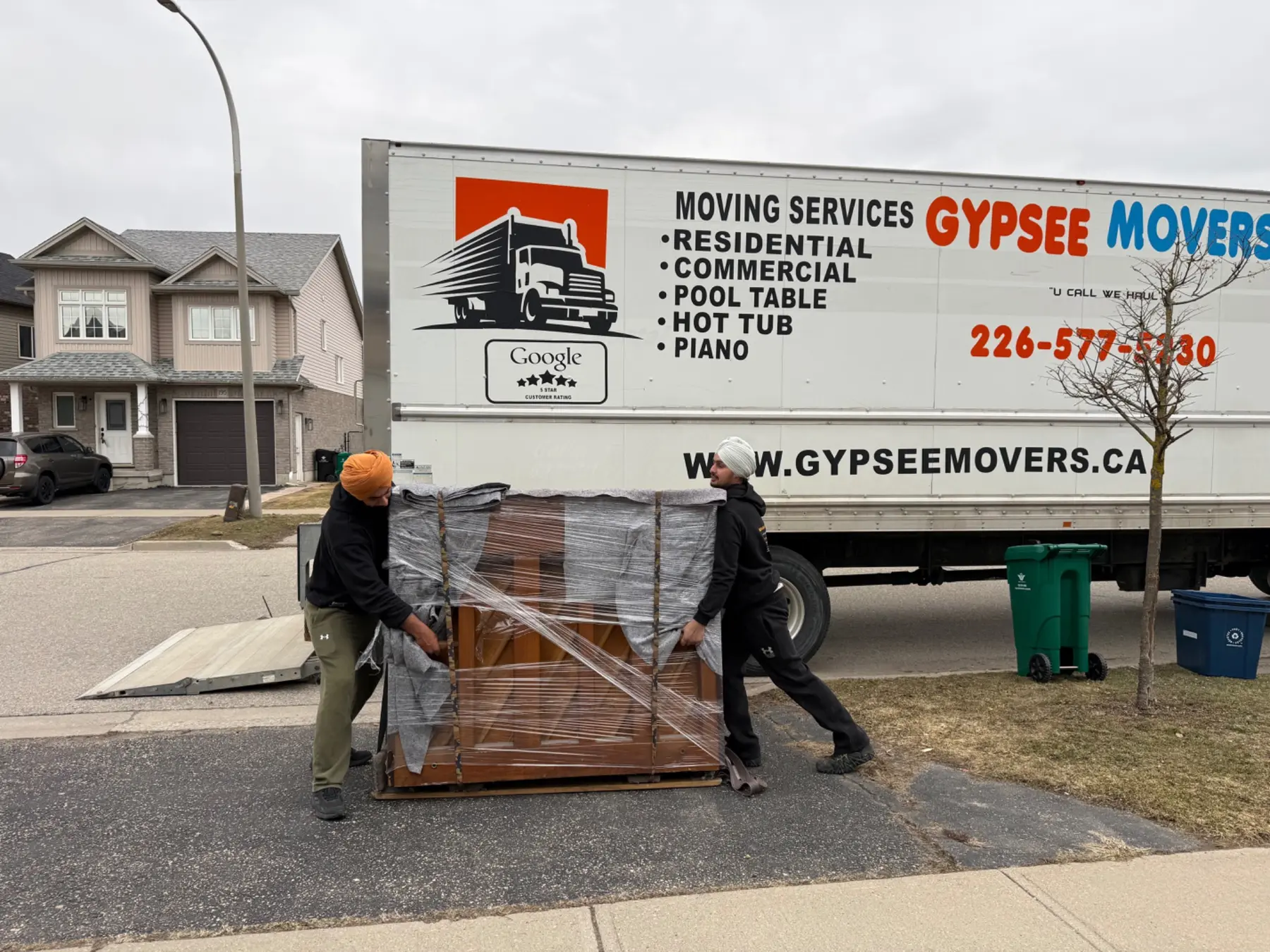 Gypsee Movers crew moving a protected upright piano in Woodstock Ontario